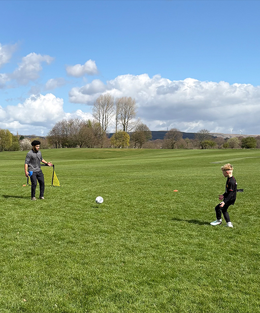 Coach giving feedback to a player during training.